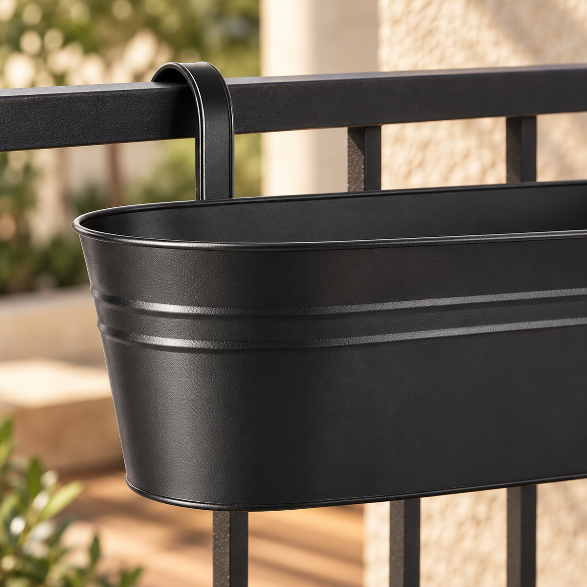 Close-up of a black planter rim, horizontal ribs and curved hanging hook